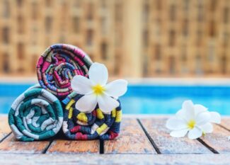 Rolled towels and plumeria flowers. Travel to Thailand